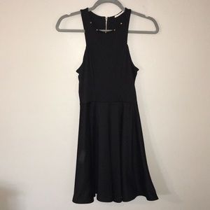 Black A-line dress with gold studs along neckline
